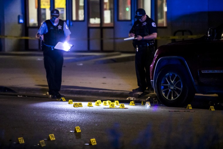 Chicago police investigate on the 800 block of South Karlov Avenue, where a 16-year-old girl was among five people seriously wounded in a shooting near Daniel Webster Elementary School in the Lawndale neighborhood on May 29, 2022.