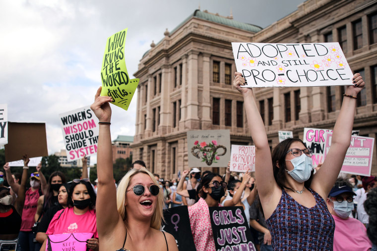 Participants part of the Women's March rally at the Texas State Capitol protest SB 8, Texas' abortion law that effectively bans abortions after six weeks of pregnancy, on Oct. 2, 2021.