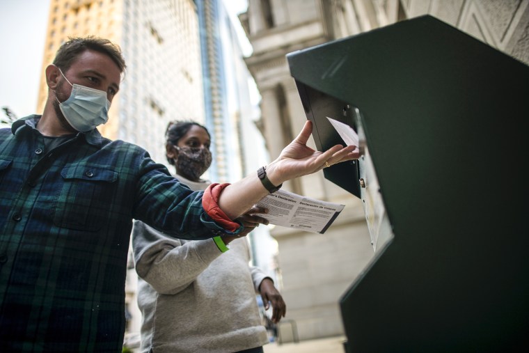 Voters cast their early voting ballot at drop box outside of City Hall on Oct. 17, 2020 in Philadelphia.