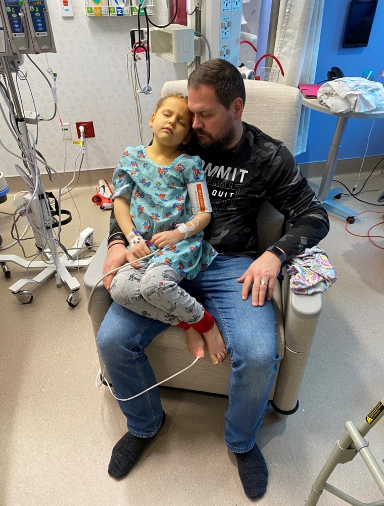 Liviah Widders with her father in the hospital.