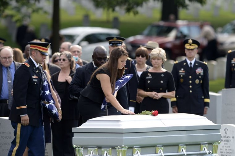 Amelia Greene with the casket of her father, U.S. Army Maj. Gen. Harold Greene, at Arlington National Cemetery.