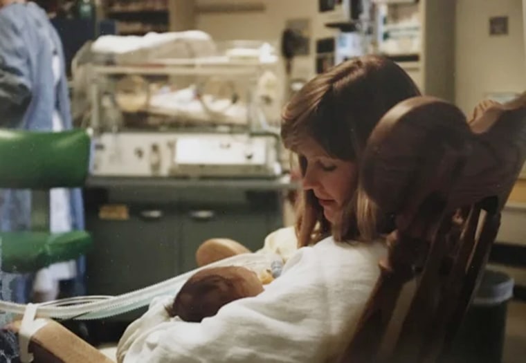 Carol Smith holds her infant son, Christopher, in the NICU. 