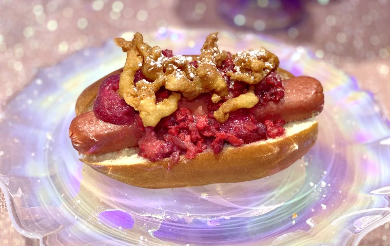 Yes, there is a hot dog topped with funnel cake on Casey’s Corner on Main Street, USA.