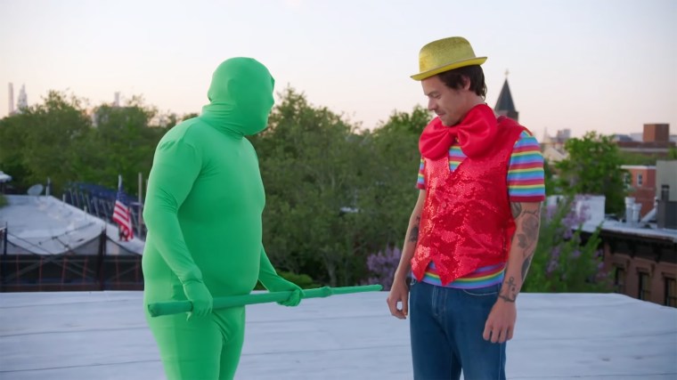 James Corden, left, in a green screen suit, and Harry Styles on a Brooklyn rooftop filming a video for Styles' song "Daylight."