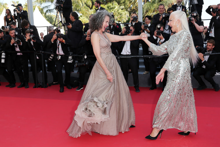 Andie MacDowell and Helen Mirren twirl each other on the red carpet ahead of the "Mother And Son (Un Petit Frere)" screening during the 75th annual Cannes Film Festival on May 27, 2022.