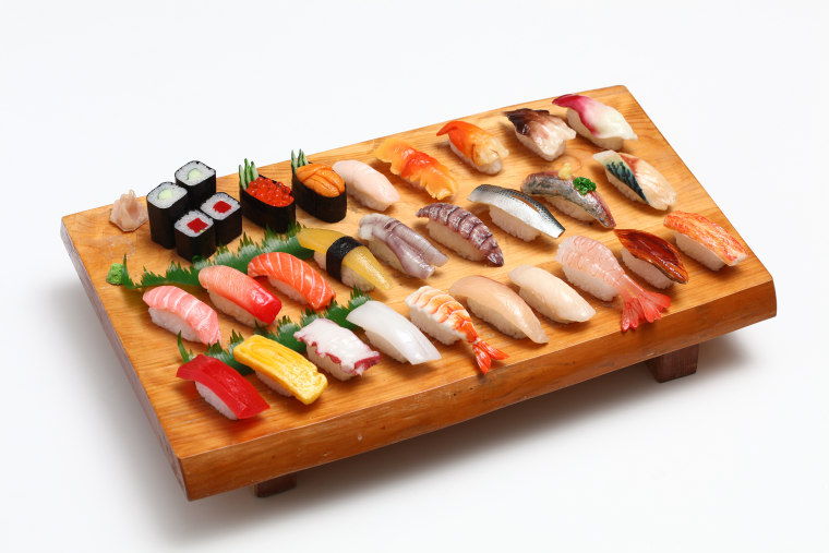 A display of nigiri and makizushi features everything from tamago (egg) nigiri to tuna maki.