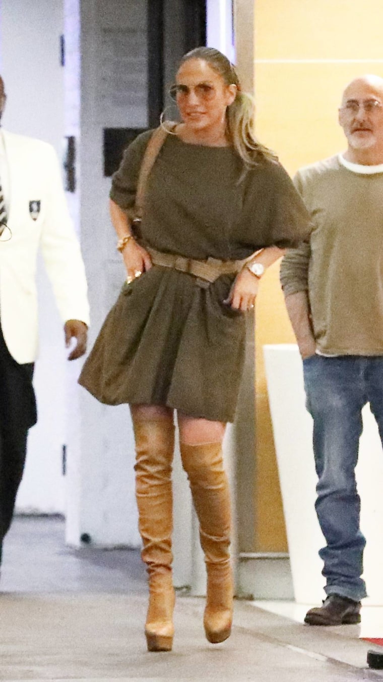 Jennifer Lopez in an olive dress and high boots at Soho House, West Hollywood, California.