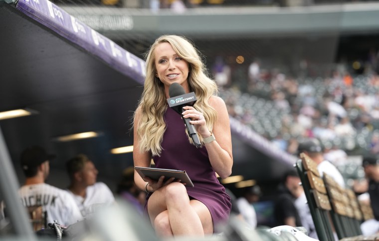 Colorado Rockies TV reporter Kelsey Wingert does a spot from the first-base well before the first inning of a game against the San Francisco Giants Monday, May 16, 2022, in Denver.