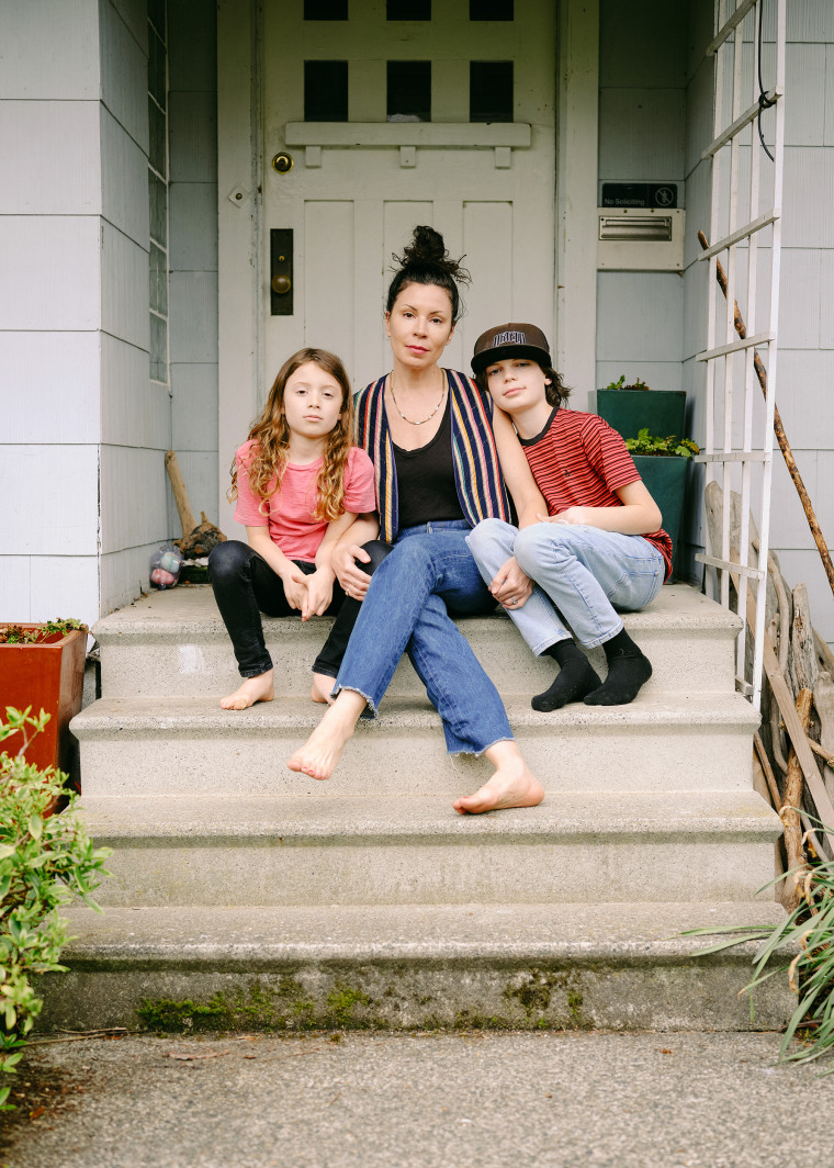 Amanda Carter Gomes, pictured with her two children outside their home.