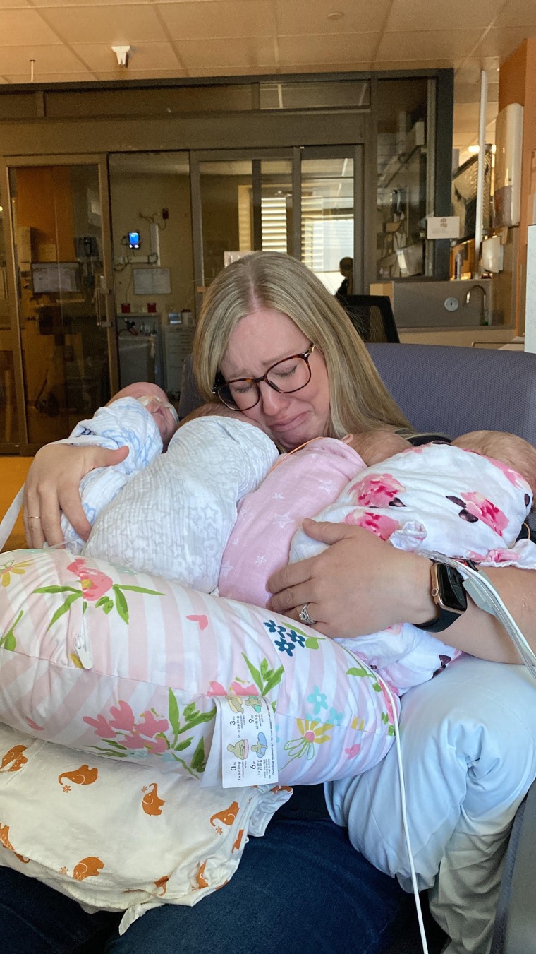 Ashley Crandell holding her quadruplets for the first time.