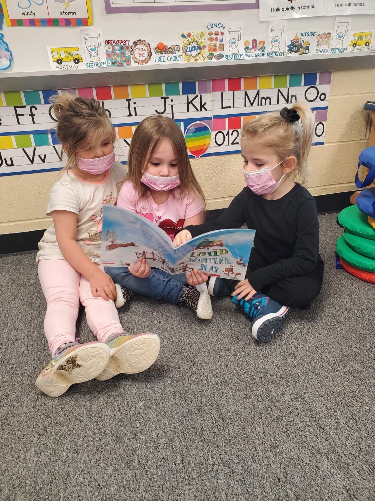 Children share a book from The LiTEArary Society.