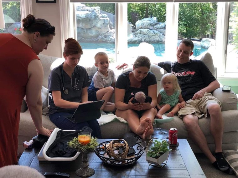 In a calmer moment at home, Heather Skaats and the family admire the new baby.