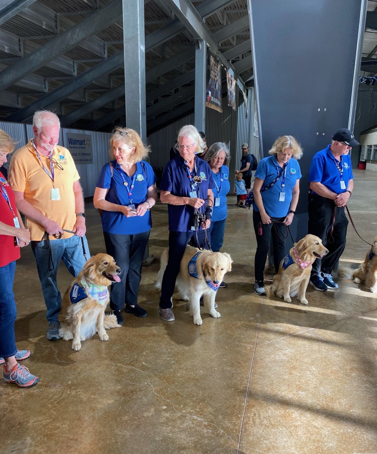Therapy dogs from another organization, lined up to meet Uvalde community members at the candlelight vigil held in the town on Wednesday evening.