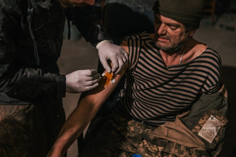 A wounded Ukrainian soldier is treated by a doctor in the Azovstal steel plant in Mariupol.