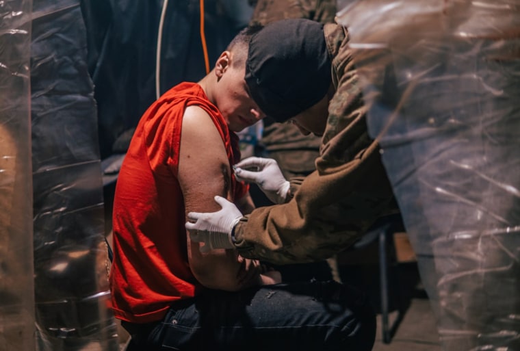 A wounded Ukrainian soldier is treated inside the steel plant in Mariupol.