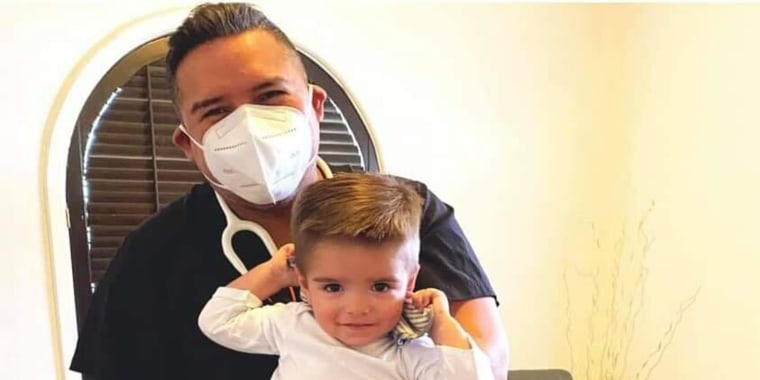 Dr. Roy Guerrero, born and raised in Uvalde, Texas, and now the only pediatrician in town, in happier times with one of his patients. He treated some of the school shooting survivors on Tuesday, and says the memories will never leave him.