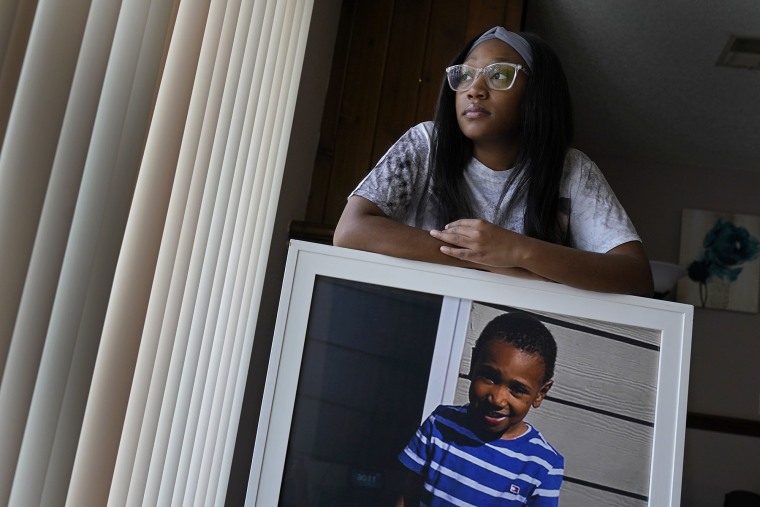 Charron Powell posa con una foto de su hijo, LeGend Talieferro, quien murió a los 4 años, en junio de 2020, cuando le dispararon mientras dormía en su casa e Missouri.