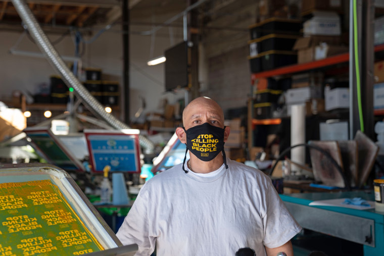Movement Ink owner René Quiñonez wears one of his masks.