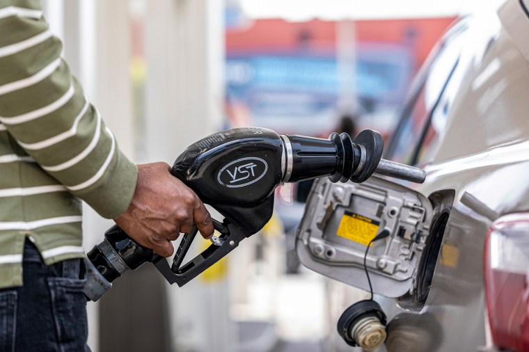 A customer holds a fuel nozzle at a gas station in San Francisco on April 27, 2022.