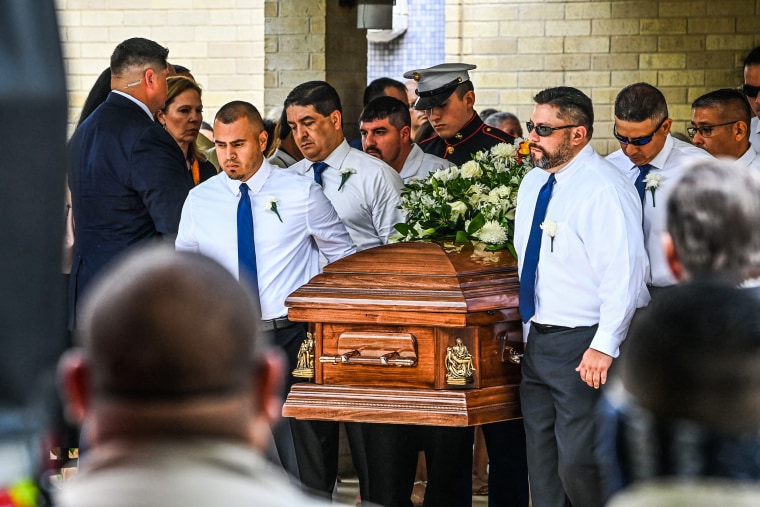 Pallbearers and U.S. Marine Christian Garcia, son of Linda Garcia, carry the caskets of Irma Linda Garcia and her husband Jose Antonio Garcia during their funeral mass at Sacred Heart Catholic Church in Uvalde, Texas, on June 1, 2022.