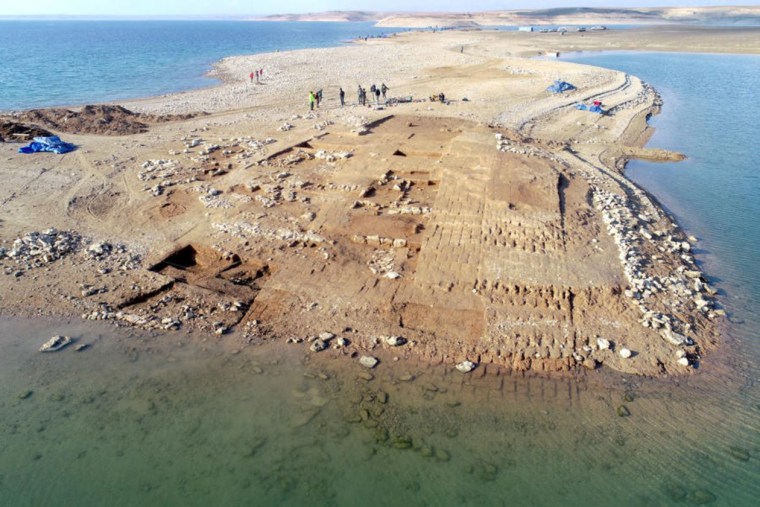Aerial view of the excavations at Kemune with Bronze Age architecture partly submerged in the lake.
