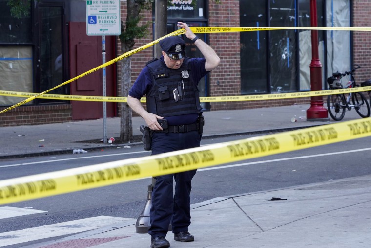 Philadelphia Police investigators work the scene of a fatal overnight shooting on South Street on June 5, 2022.