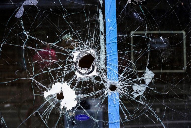 A storefront window with bullet holes is seen following a fatal overnight shooting on South Street in Philadelphia on June 5, 2022.
