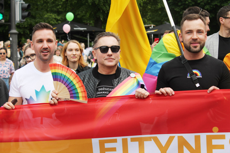 Image: Mayor Colin Ratushniak of LaRoche, Canada, left, Vladimir Simonko and Tomas Raskevičius at the Baltic Pride march in Vilnius, Lithuania, on June 5, 2022.