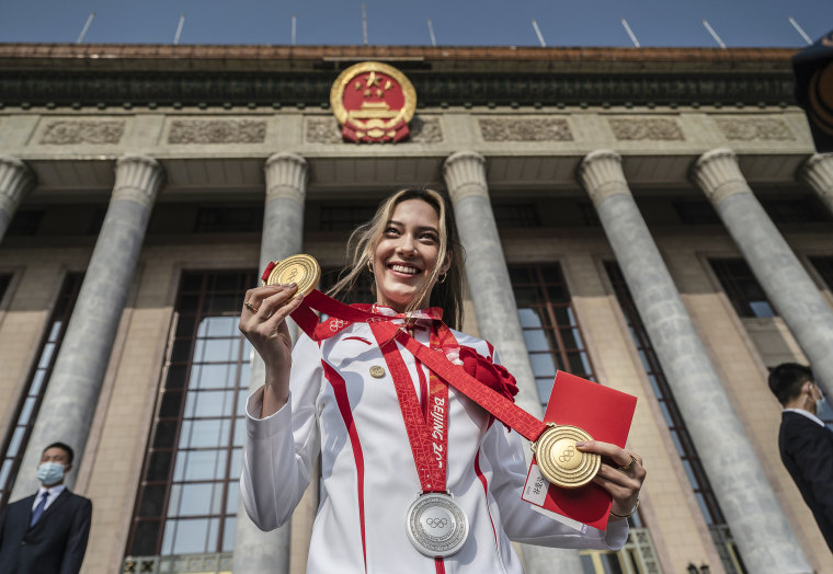 U.S. born freestyle skier Eileen Gu, or Gu Ailing, poses with her two gold medals and a silver medal before a ceremony to honor the contributions to the Beijing 2022 Winter Olympics and Paralympics at the Great Hall of the People on April 8, 2022 in Beijing.