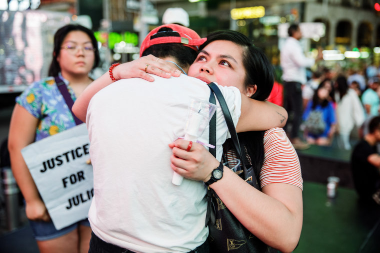 Karinina Quimpo hugs a friend during a vigil for Julio Ramirez on June 8, 2022, in New York. Quimpo was friends with Ramirez for a decade.