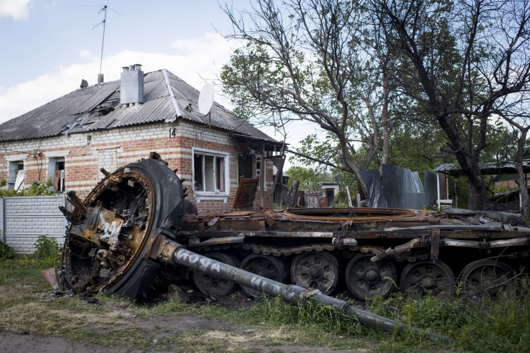 A destroyed tank, its turret separated from its chassis, lies next to the road in Mala Rohan in May.