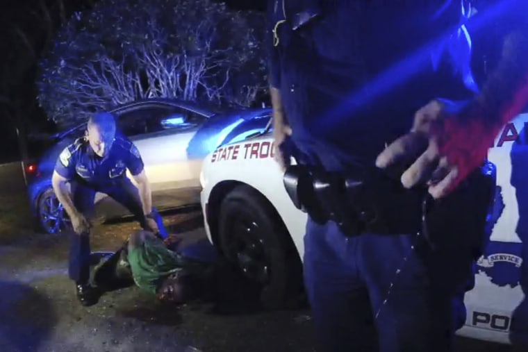 Louisiana State Troopers stand over Ronald Greene, lying on his stomach, outside of Monroe, La., on May 10, 2019.