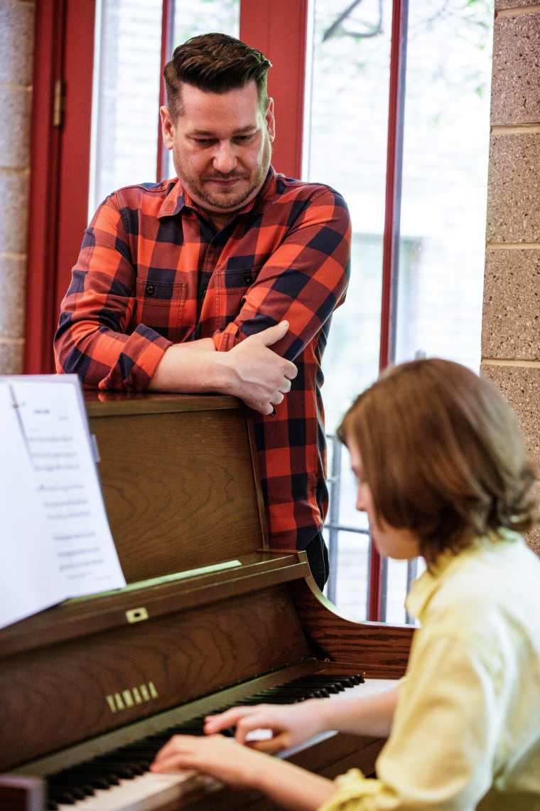 Steven Kroeze watches as Michael Coppola plays the piano during a vocal lesson at Trinity Lower East Side Lutheran Parish on May 28, 2022, in New York.