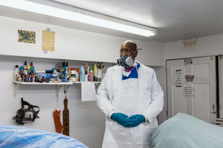 Image: Dr. Hari P. Close II, 61, the President of the National Funeral Directors & Morticians Association and also a longtime embalmer and funeral home owner in his restorative work uniform in Baltimore, on June 11, 2022.