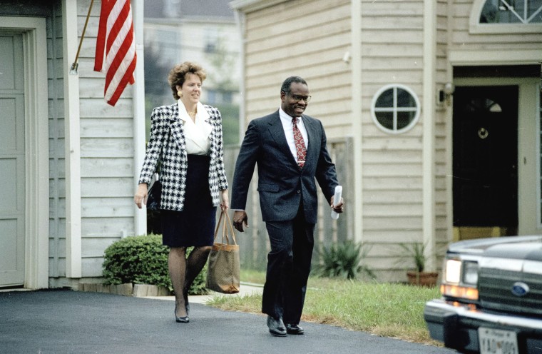 Supreme Court nominee Clarence Thomas leaves his Alexandria, Va., home, Oct. 11, 1991, with his wife Virginia.