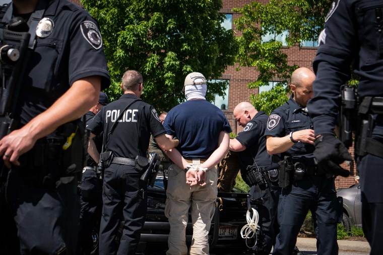 Image: Police search members of the white nationalist group Patriot Front who were arrested outside of Mceuen Park in Coeur d' Alene, Idaho, on June 11, 2022.