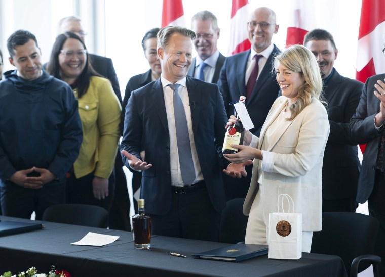 The countries' foreign ministers traded gifts after signing the agreement on Tuesday in Ottawa. 