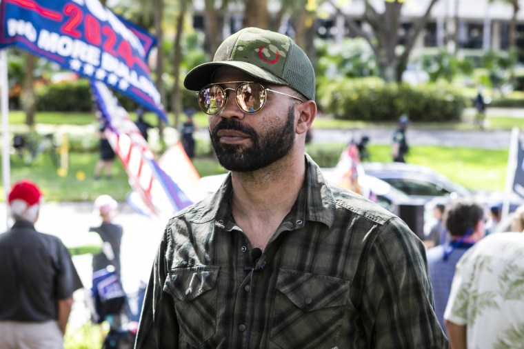 Enrique Tarrio, leader of the Proud Boys, stands outside the Hyatt Regency Hotel during Conservative Political Action Conference in Orlando, Fla., on Feb. 28, 2021.