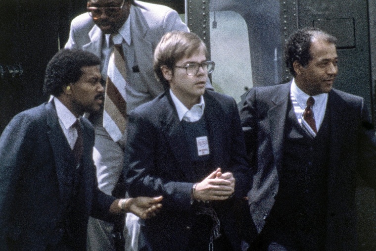 U.S. Marshalls escort John Hinckley Jr. as he returns to a marine base via helicopter in Quantico, Va., on Aug. 8, 1981.