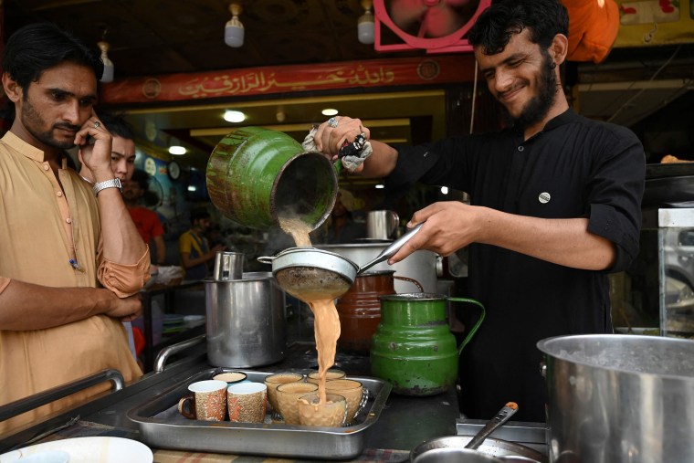 Image: An employee pours tea for customers at a restaurant in Islamabad, Pakistan, June 15, 2022.