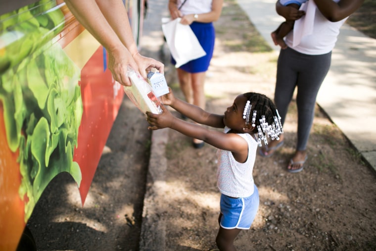 A child in Greater New Haven receives summer meals distributed by food truck.