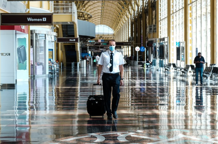 A pilot walks through the terminal