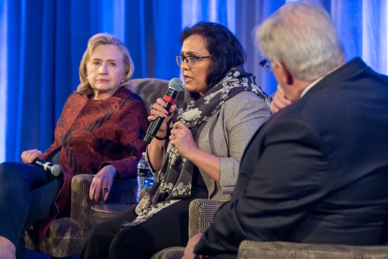 Women's rights advocate Roshan Mashal, center, and Hillary Clinton, left, receive awards from Refugees International, a nonprofit organization promoting human rights for refugees, on May 11, 2022.