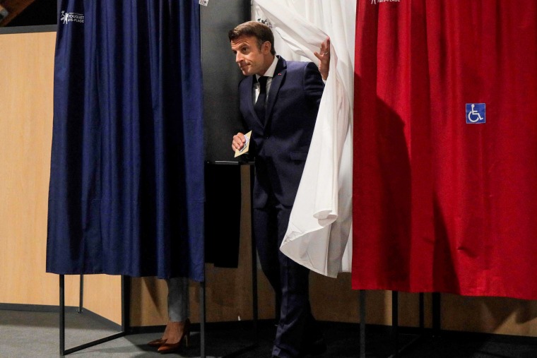 France's President Emmanuel Macron leaves the voting booth as he votes in the second stage of French parliamentary elections at a polling station in Le Touquet, northern France, on June 19, 2022.