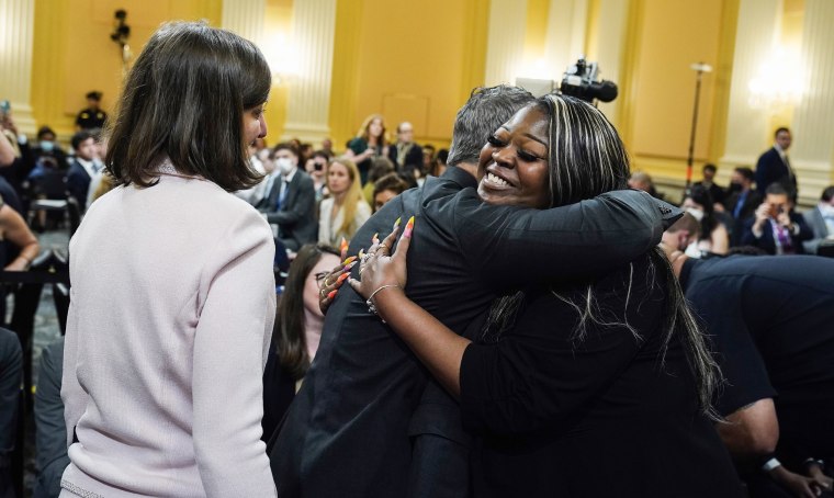 Image: Rep. Adam Kinzinger, R-Ill., center, hugs former Georgia Election worker Shaye Moss, as Rep. Elaine Luria, D-Va. looks on after the hearing on  June, 21 2022.