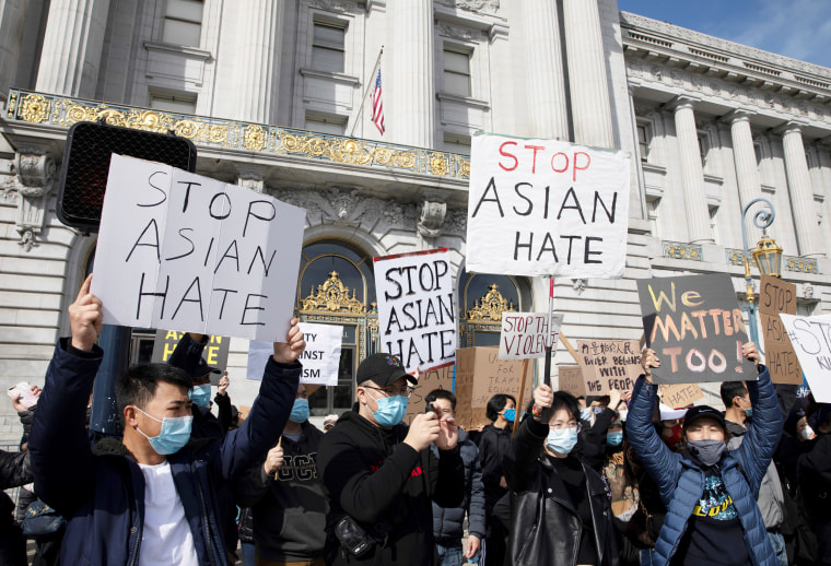 People take part in a protest against Asian hate