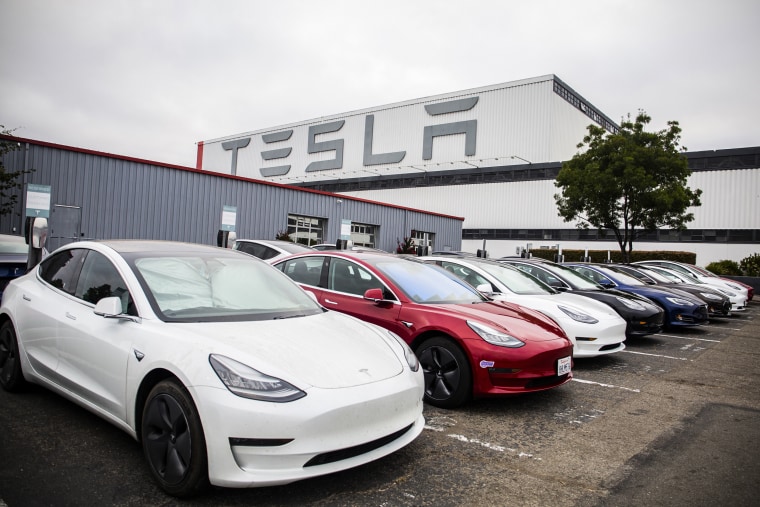 Tesla Inc. electric vehicles charge at the Tesla Supercharger station in Fremont, Calif., on July 20, 2020.