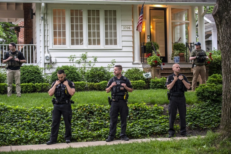 Police officers stand outside the home of U.S. Supreme Court Justice Brett Kavanaugh in anticipation of an abortion-rights demonstration on May 18, 2022 in Chevy Chase, Md.