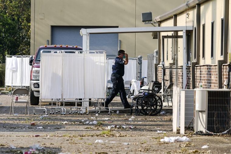 An EMS technician walks where people were evacuated at a mass shelter in the aftermath of Hurricane Ida, on Sept. 2, 2021, in Independence, La.