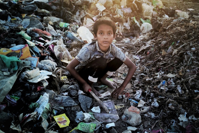 Absar, 6, sells plastic bottles he collects to support his family.